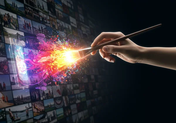 Digital hand transforming photo into art with AI tools